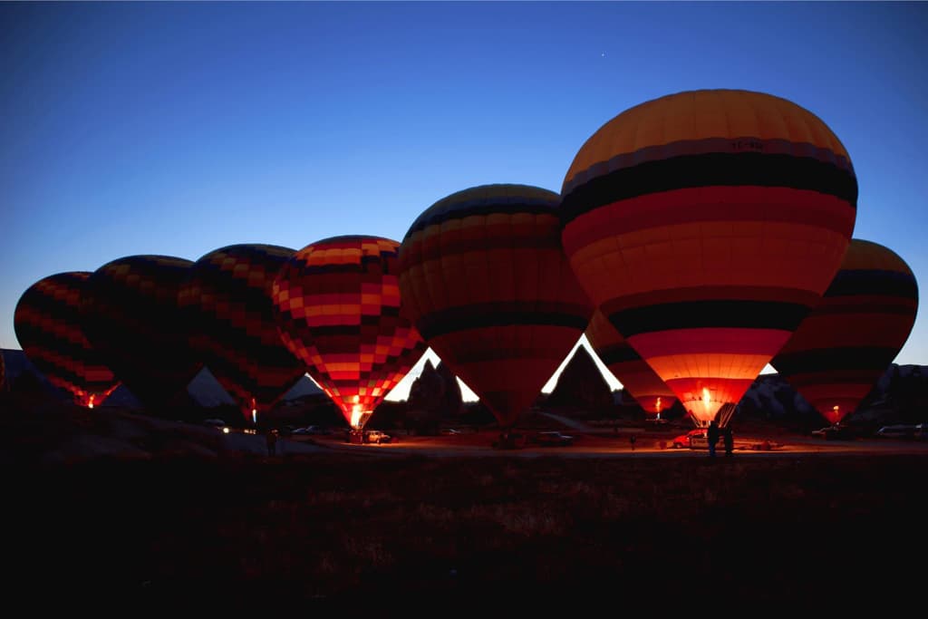 On the departure area of balloons. It is like a balloon festival, dozens of colorful huge hot air balloons!